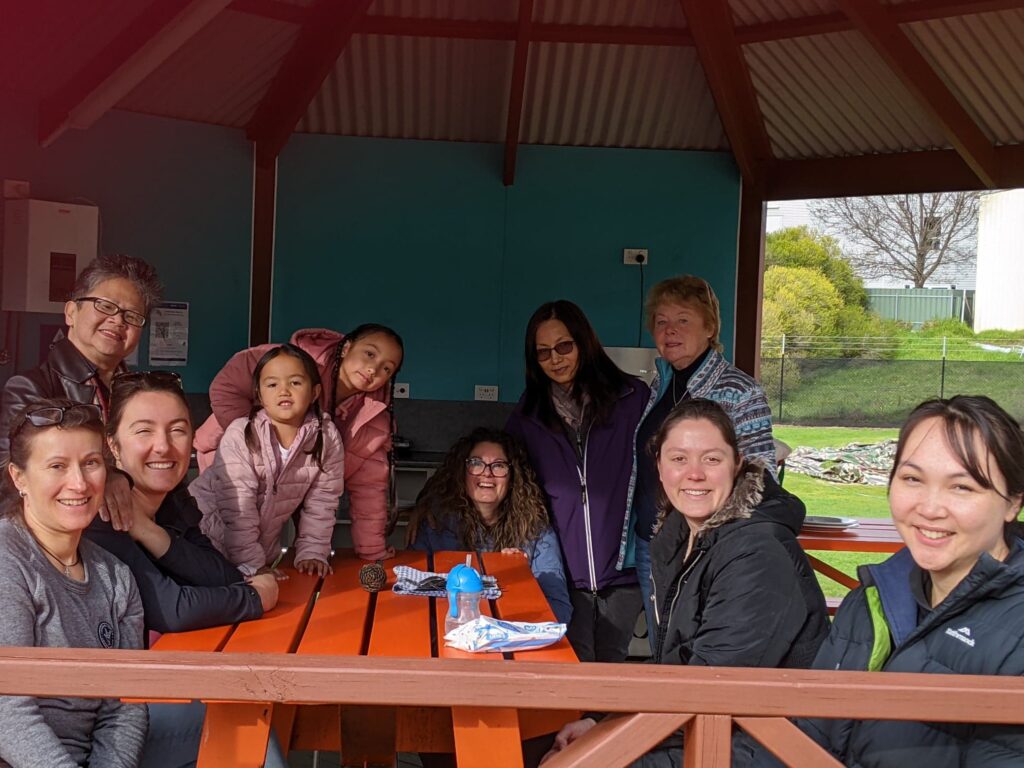 Sitting around ready for breakfast to be served on a Church Camp.